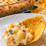 Creamy cheesy corn and green chile dip served warm with corn chips